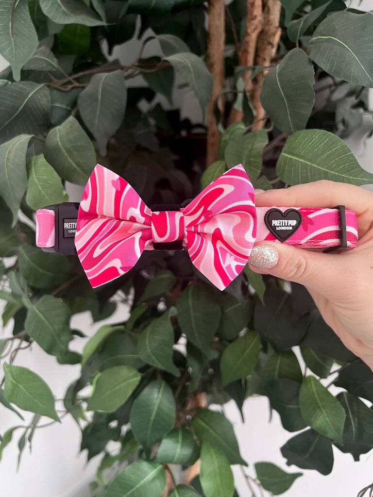 pink dog bow tie collar being held up for a photo