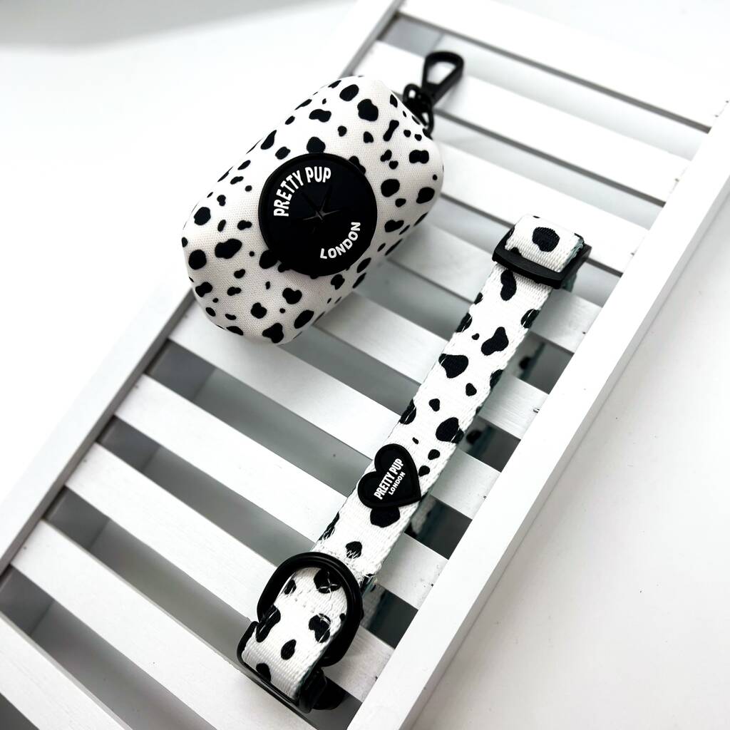 dalmatian print dog poo bag holder attached to a slated board