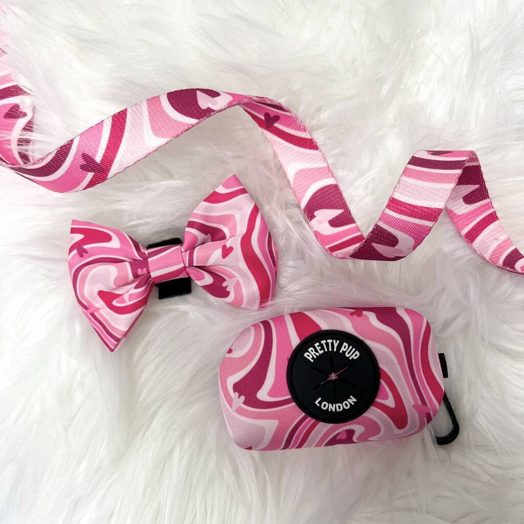 seventies pink swirl pattern on a designer dog lead, dog poo bag dispenser and pink dog bow