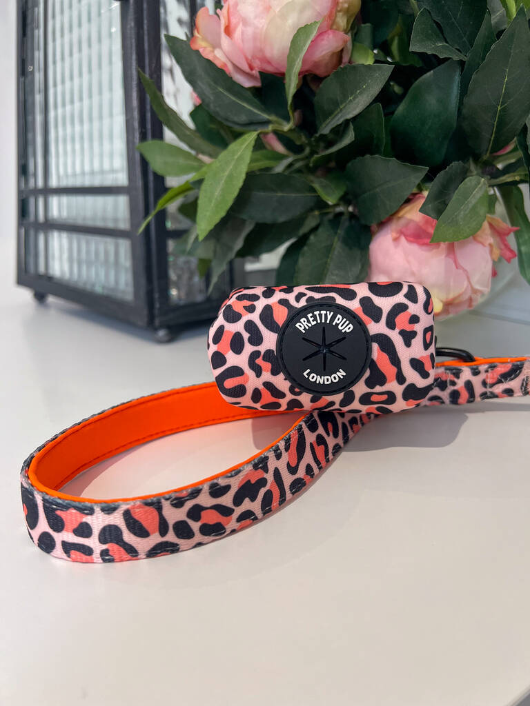 orange leopard print dog lead handle and dog poo bag dispenser attached