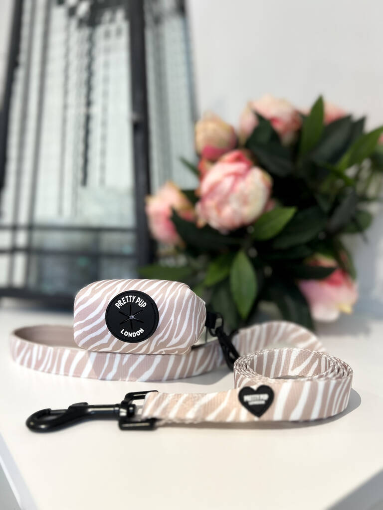 beige zebra print dog poo bag dispenser attached to matching dog lead 